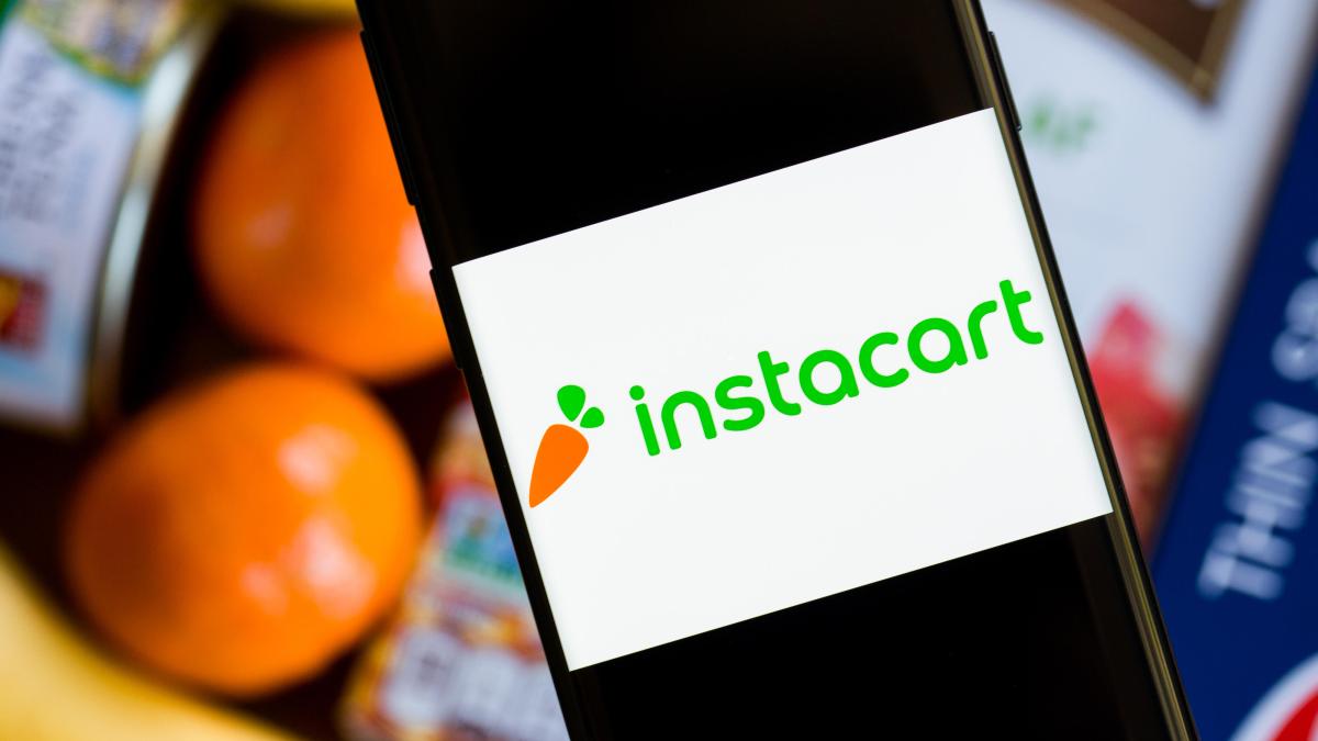 Instacart logo on phone in front of food